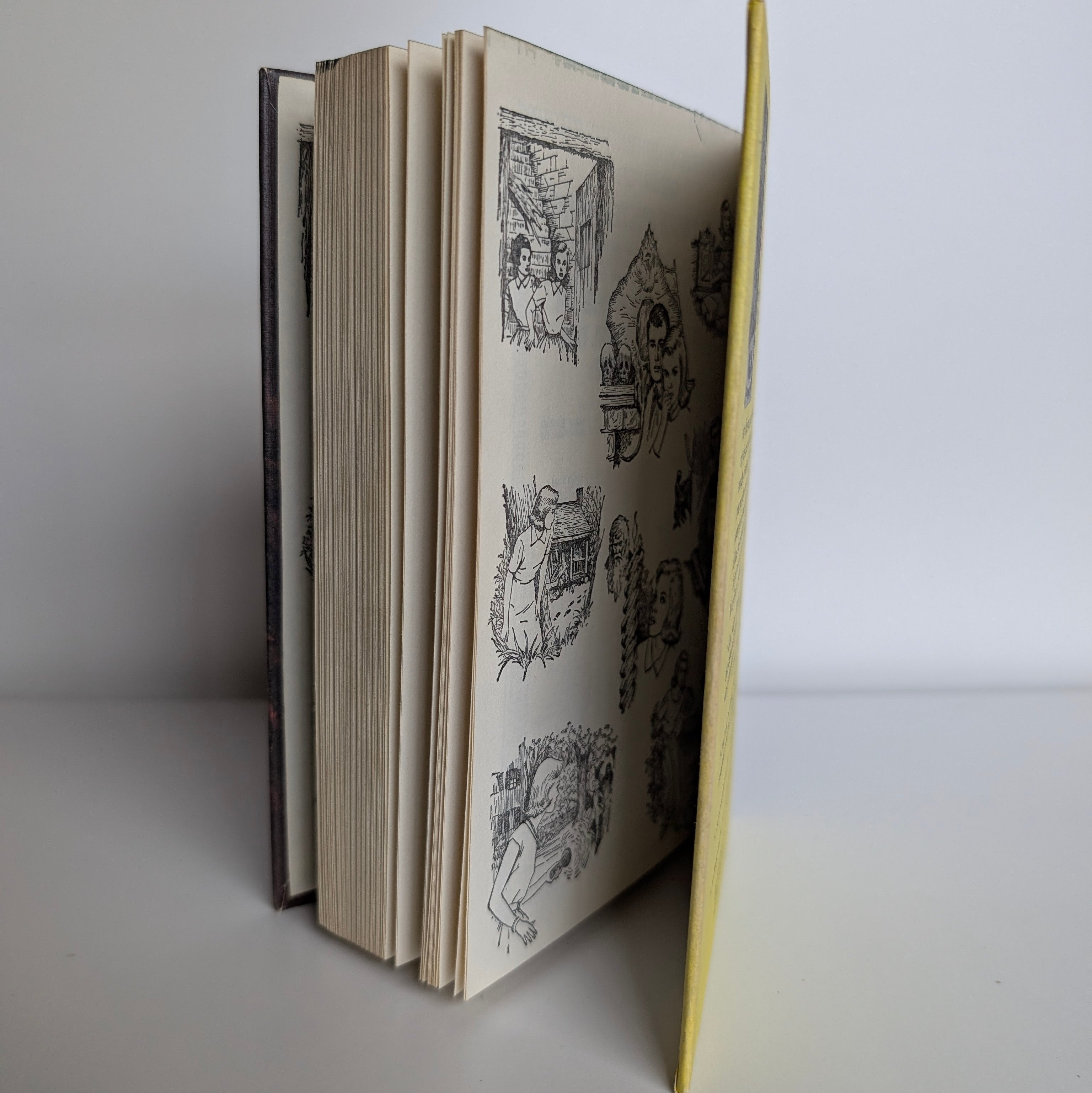 Vintage Nancy Drew Mystery of the Glowing Eye book open to illustrated pages by Grosset & Dunlap Inc 1974 edition