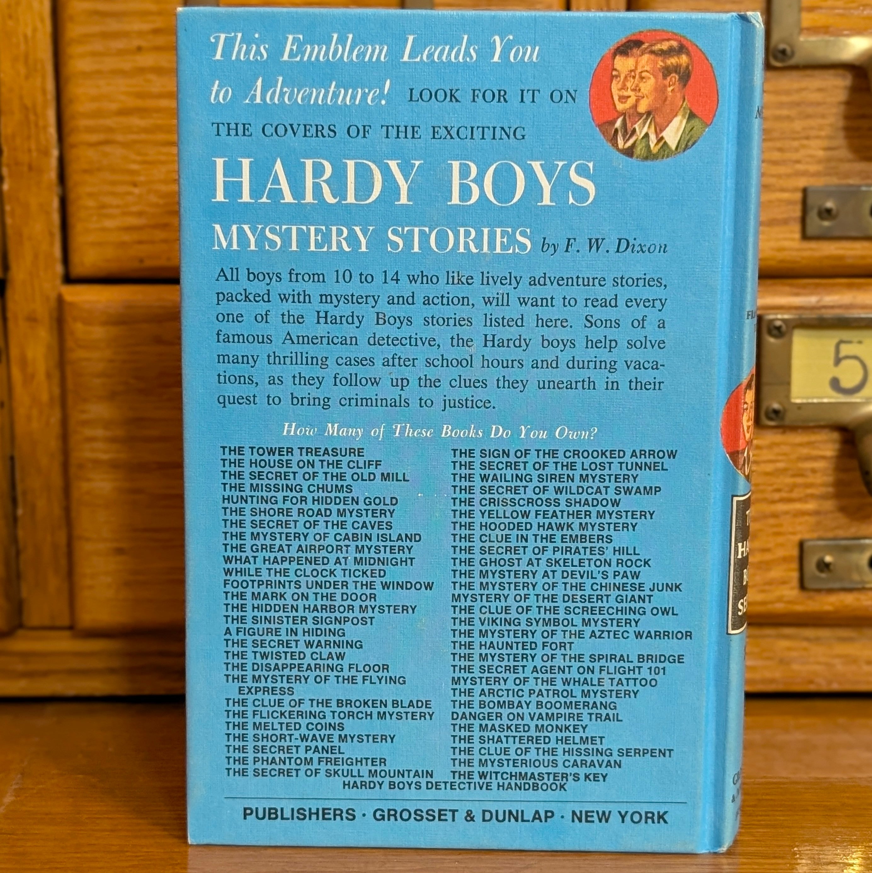 Vintage Hardy Boys book titled The Short Wave Mystery by Grosset & Dunlap, Inc. with blue cover and text details