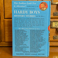 Vintage Hardy Boys book titled The Short Wave Mystery by Grosset & Dunlap, Inc. with blue cover and text details
