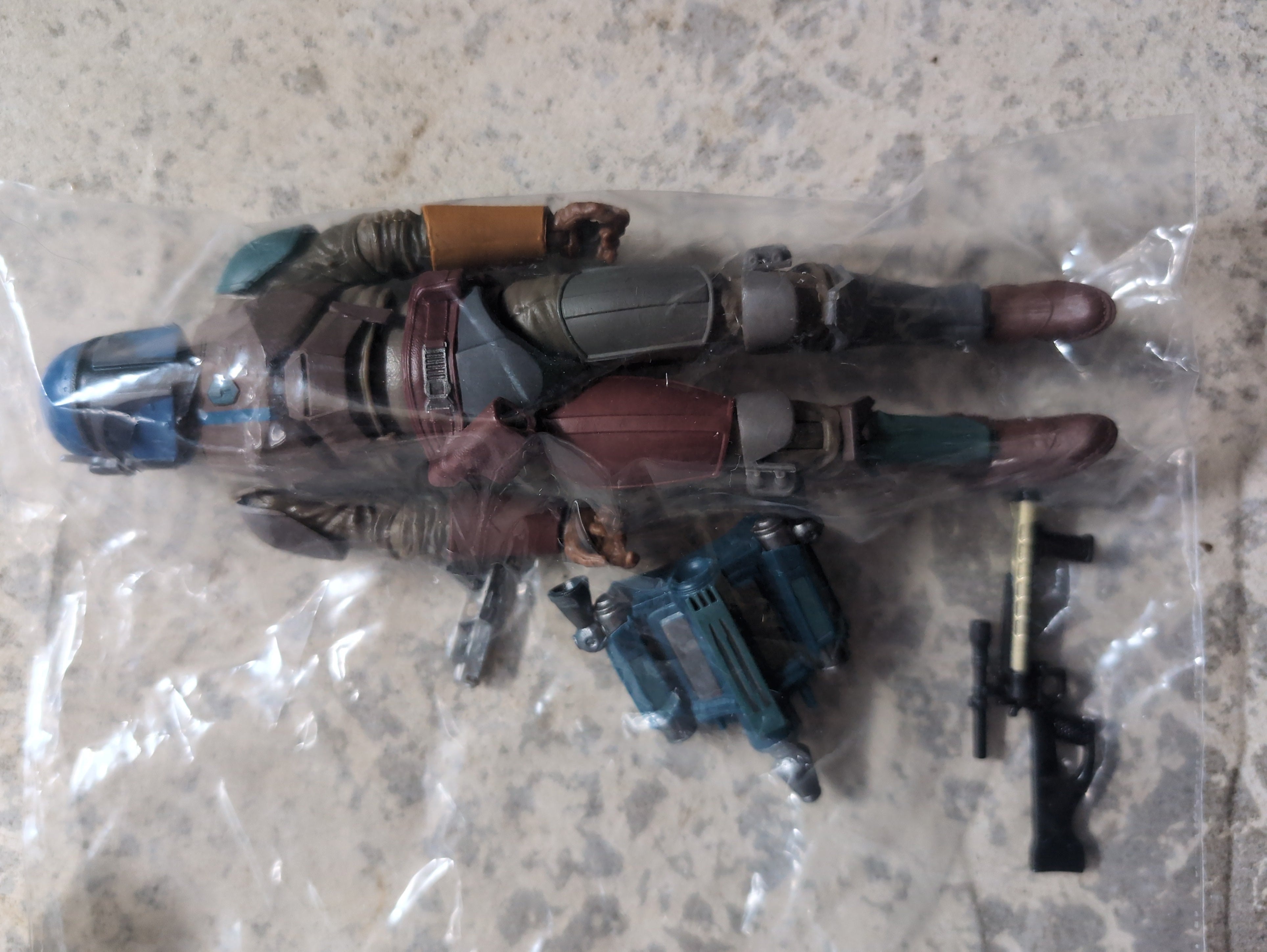 Hasbro Star Wars Shriek Hawk Trainer action figure loose with weapons and jetpack accessories on stone background