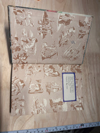 Inside cover of 1929 Hardy Boys The Secret of the Caves vintage book with illustrated endpaper and label from Grosset & Dunlap, Inc.