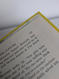 Vintage 1971 Grosset & Dunlap Nancy Drew The Crooked Banister yellow hardcover book with white endpages close-up page text
