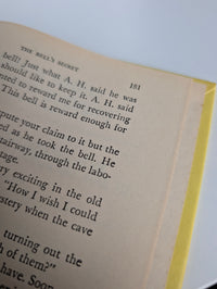 Close-up of page 181 from The Mystery of the Tolling Bell by Grosset & Dunlap Inc. with yellow book edge visible