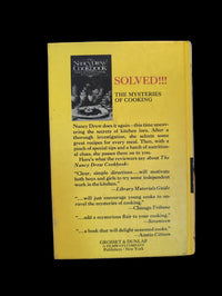 Back cover of The Nancy Drew Cookbook by Grosset & Dunlap, Inc. featuring cooking mysteries and reviews.