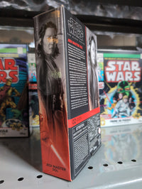 Hasbro Star Wars Black Series Jedi Master Sol action figure box showing character art and details on shelf with puzzles behind