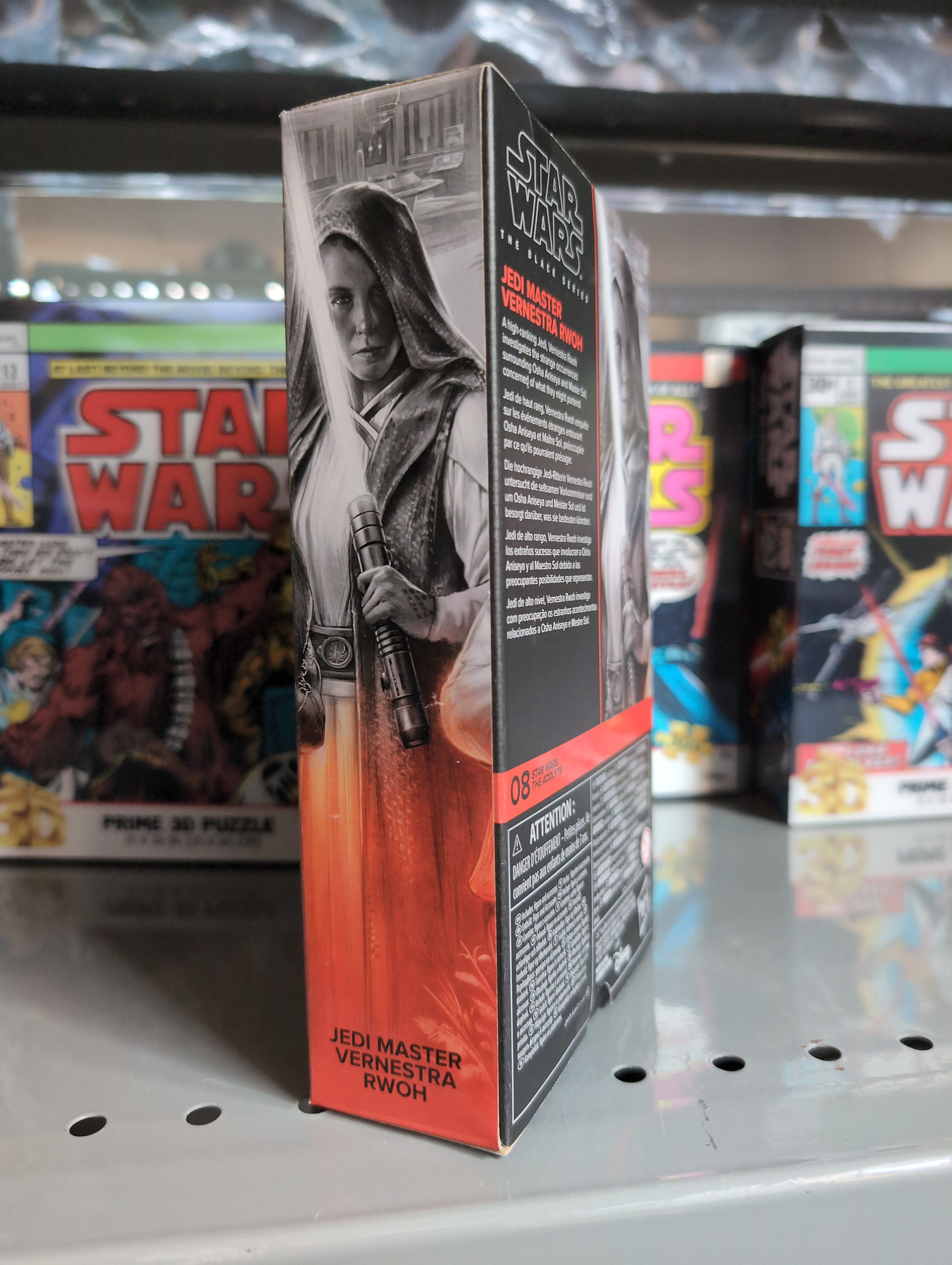 Hasbro Star Wars Black Series Vernestra Rwoh Jedi Master action figure packaging on a store shelf display.