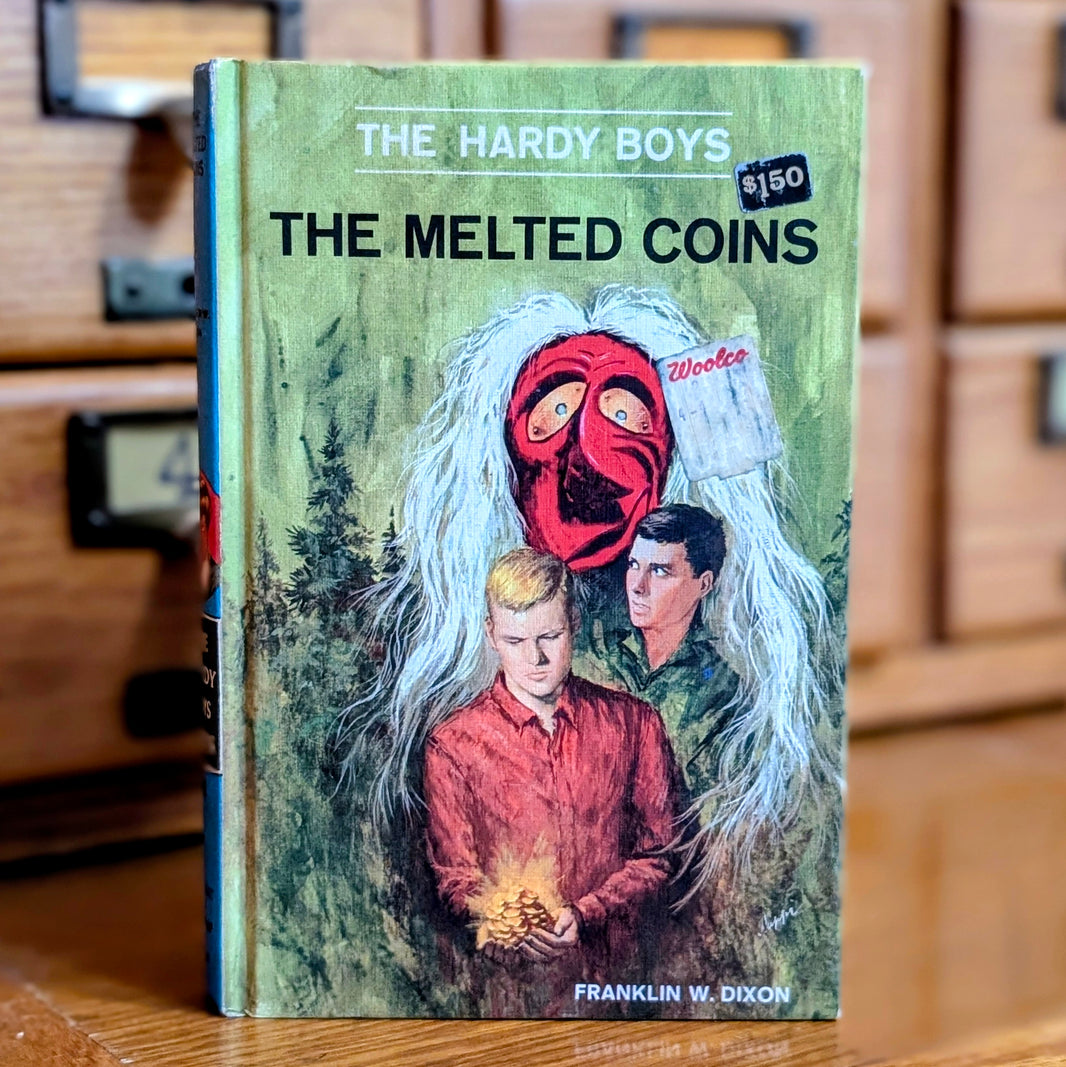 Vintage 1970 Hardy Boys book The Melted Coins by Grosset & Dunlap featuring two boys and a red mask on cover