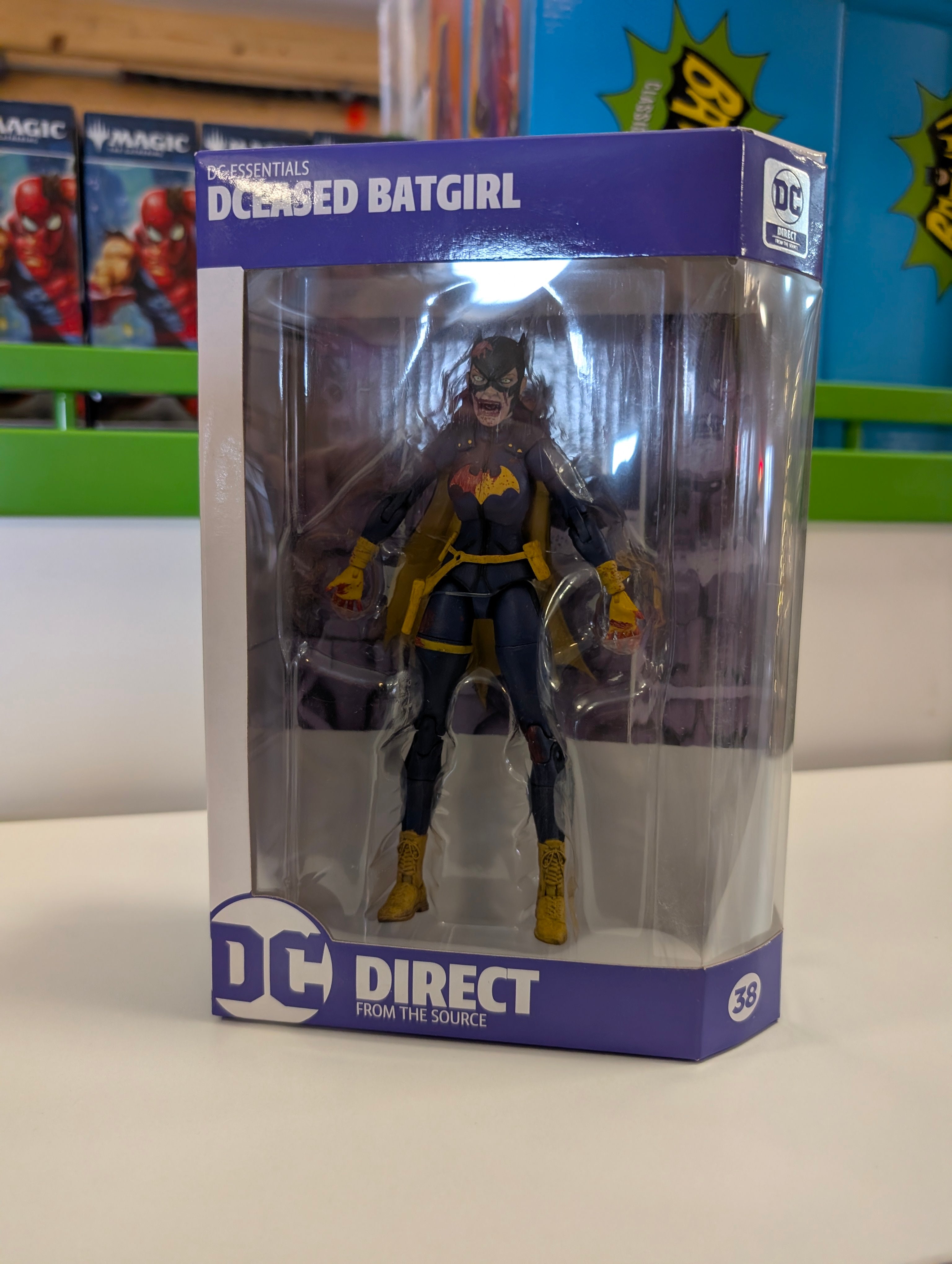 DC Direct Essentials DCeased Batgirl 6-inch action figure in packaging with torn costume and fierce expression