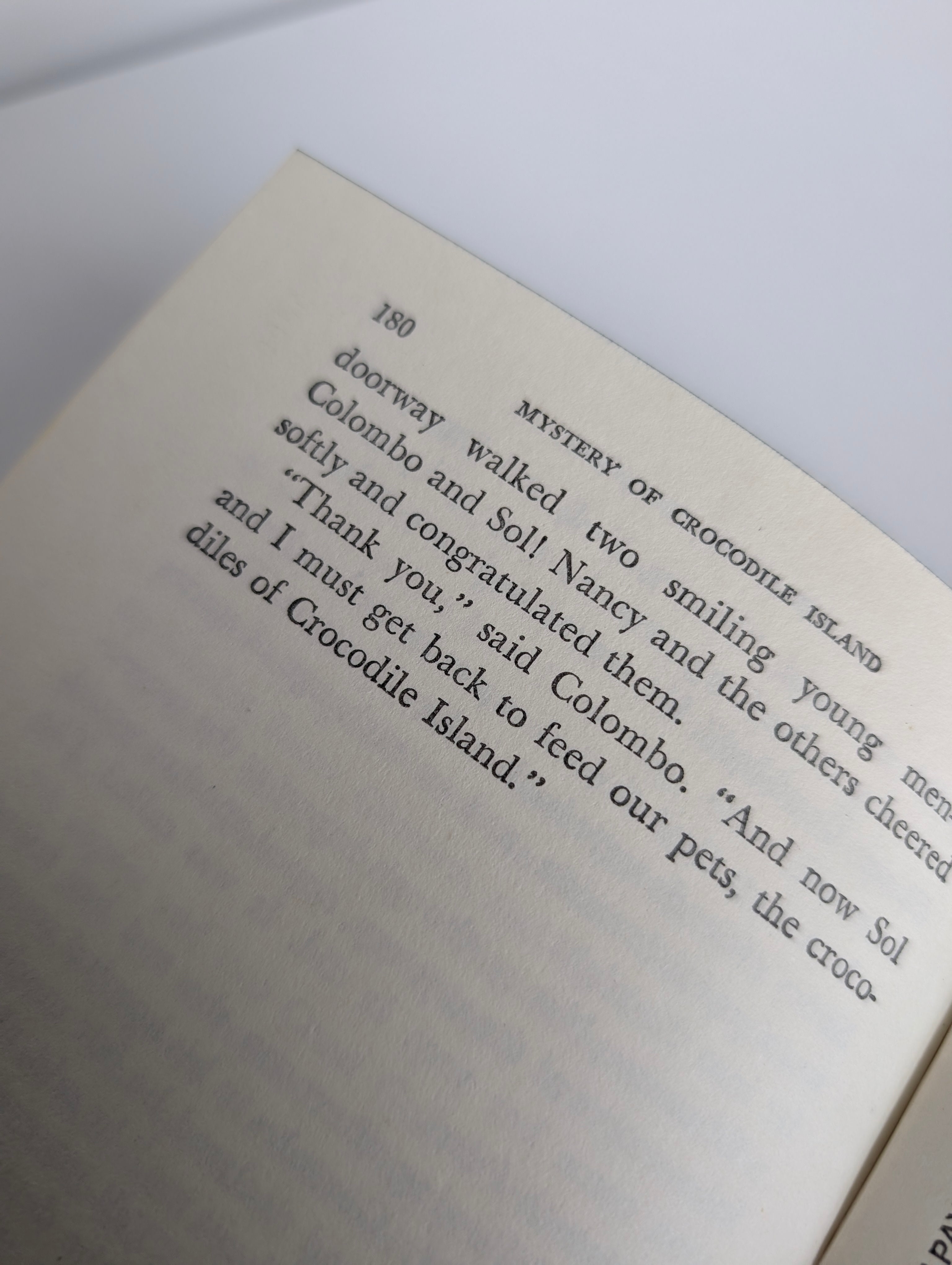 Close-up of page 180 from 1978 Grosset & Dunlap Nancy Drew Mystery of Crocodile Island book with dialogue text