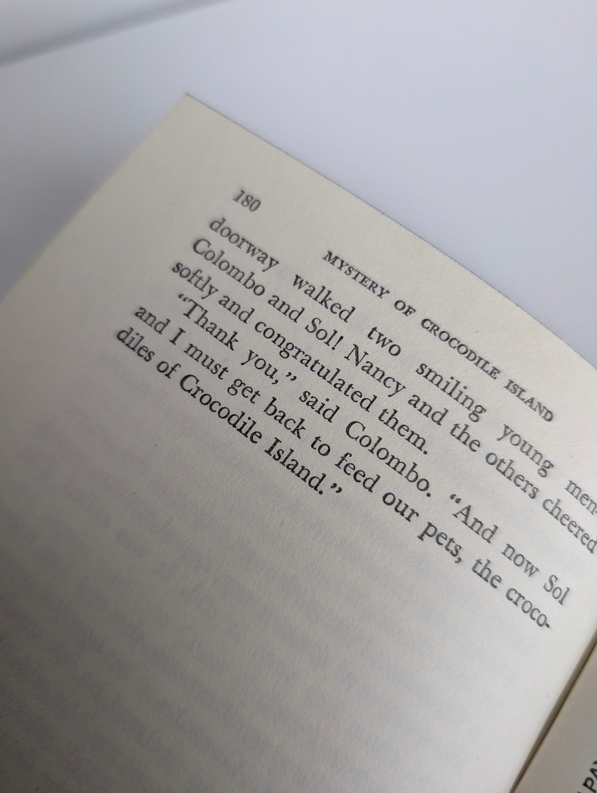Close-up of page 180 from 1978 Grosset & Dunlap Nancy Drew Mystery of Crocodile Island book with dialogue text