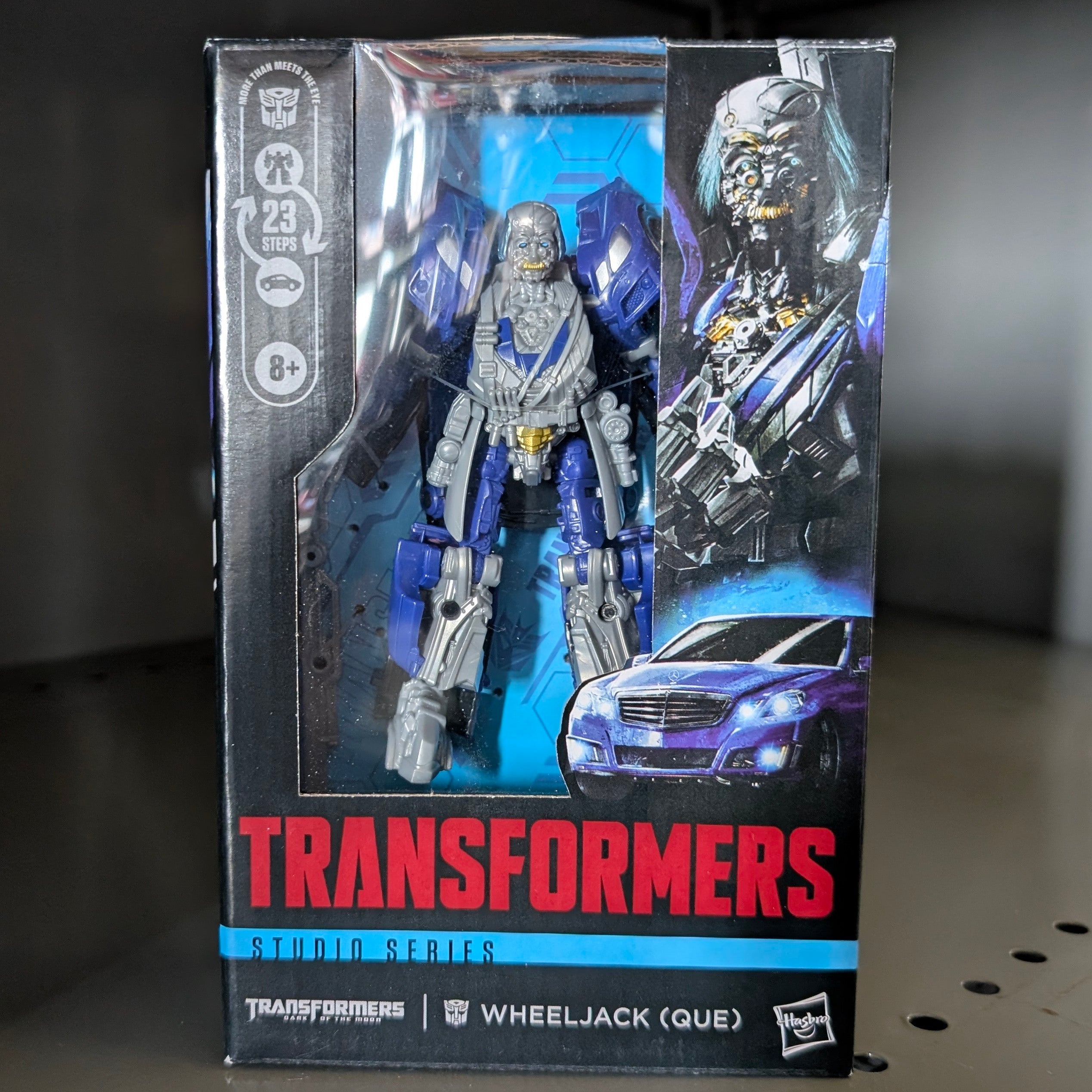 Wheeljack Transformers:Dark of the Moon Studio Series Action Figure by Hasbro in collectible packaging with robot and vehicle artwork.
