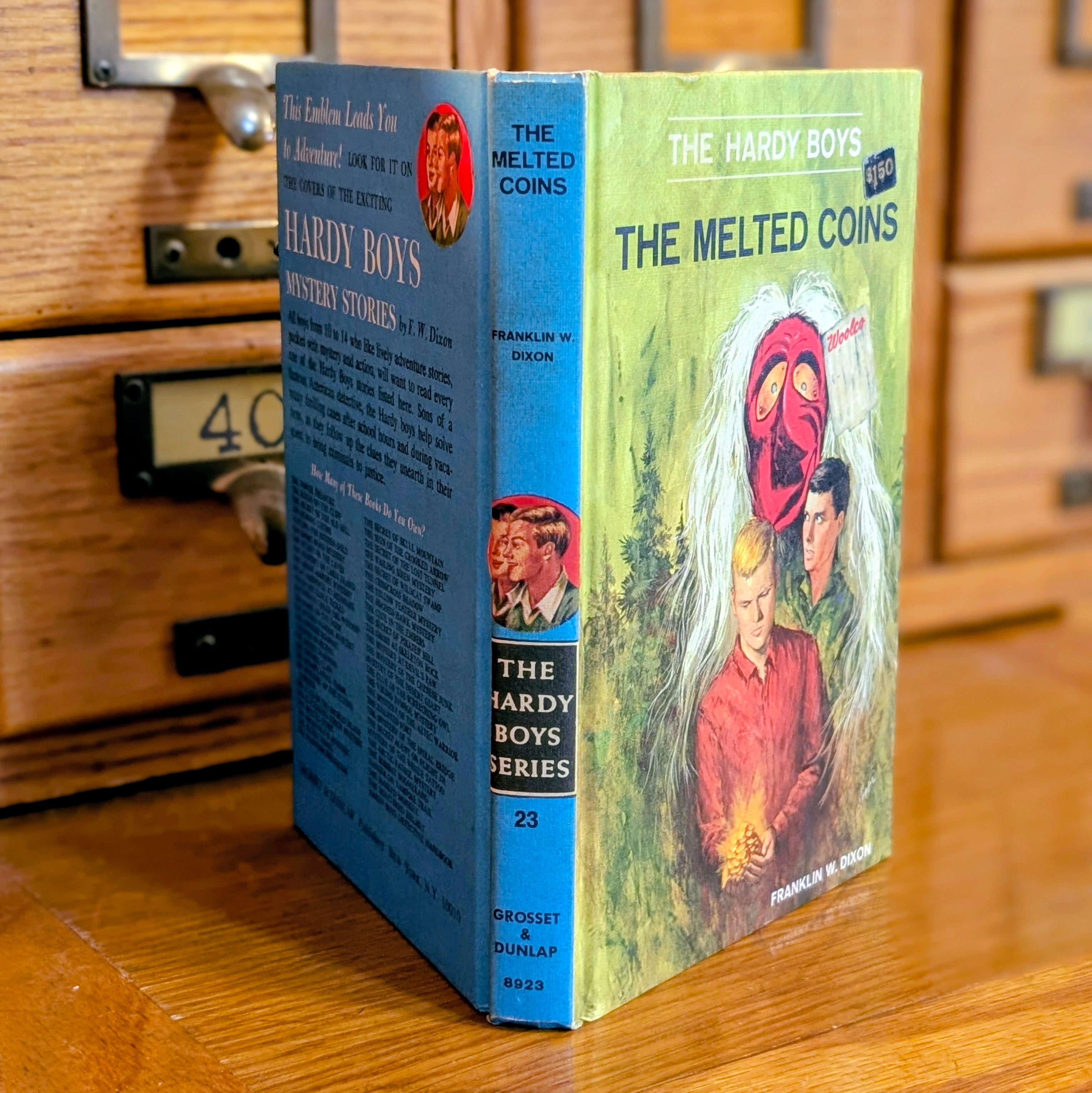 Vintage 1970 Hardy Boys book The Melted Coins by Grosset & Dunlap, Inc. with blue back cover and illustrated front