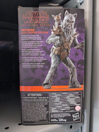 Hasbro Star Wars Black Series Halloween Wookiee action figure with werewolf head sculpt and accessories on collector box.