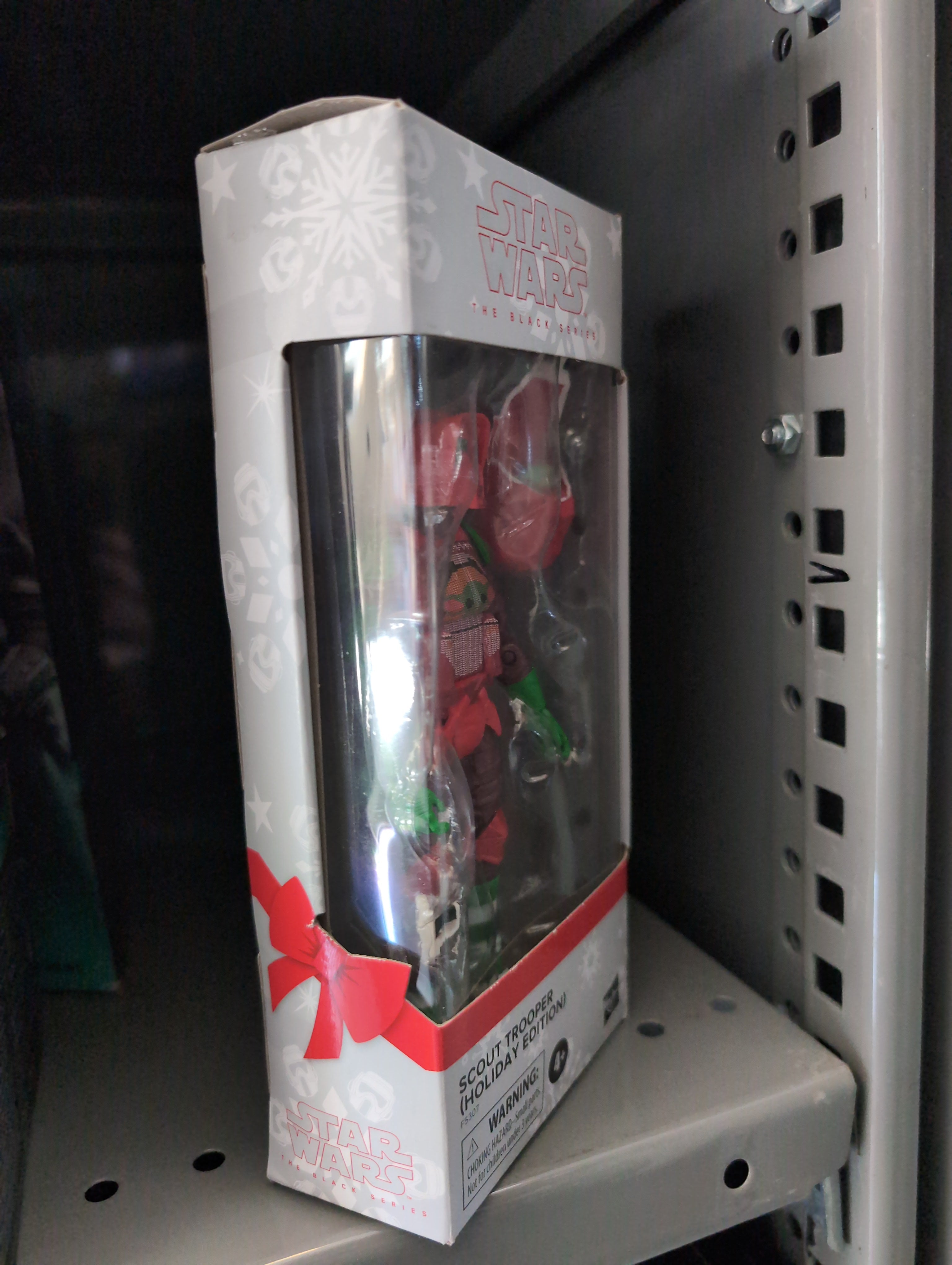 Hasbro Star Wars Christmas Biker Scout action figure in festive holiday packaging on a shelf