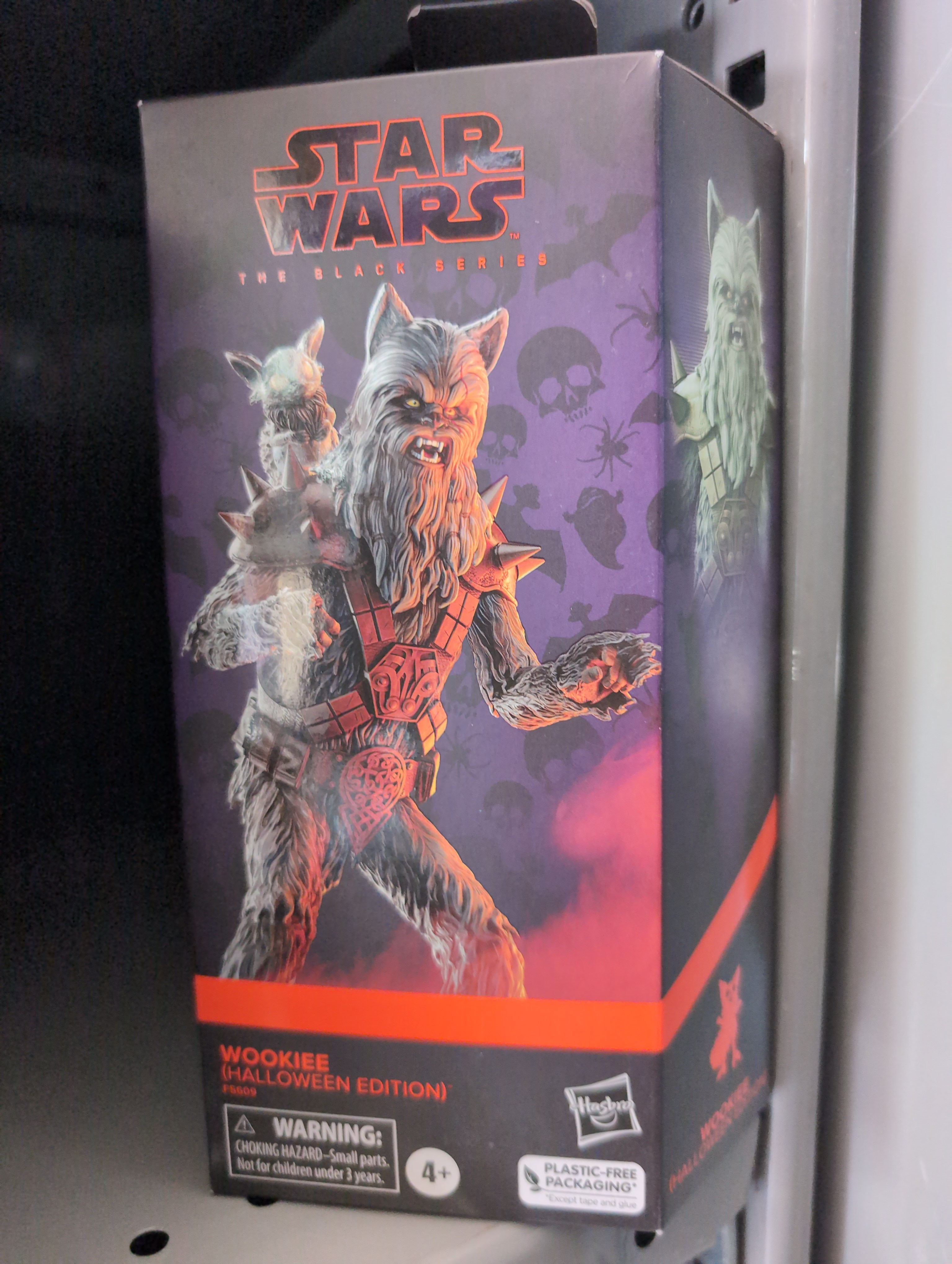 Hasbro Star Wars Black Series Halloween Wookiee action figure in collector packaging with spooky background design