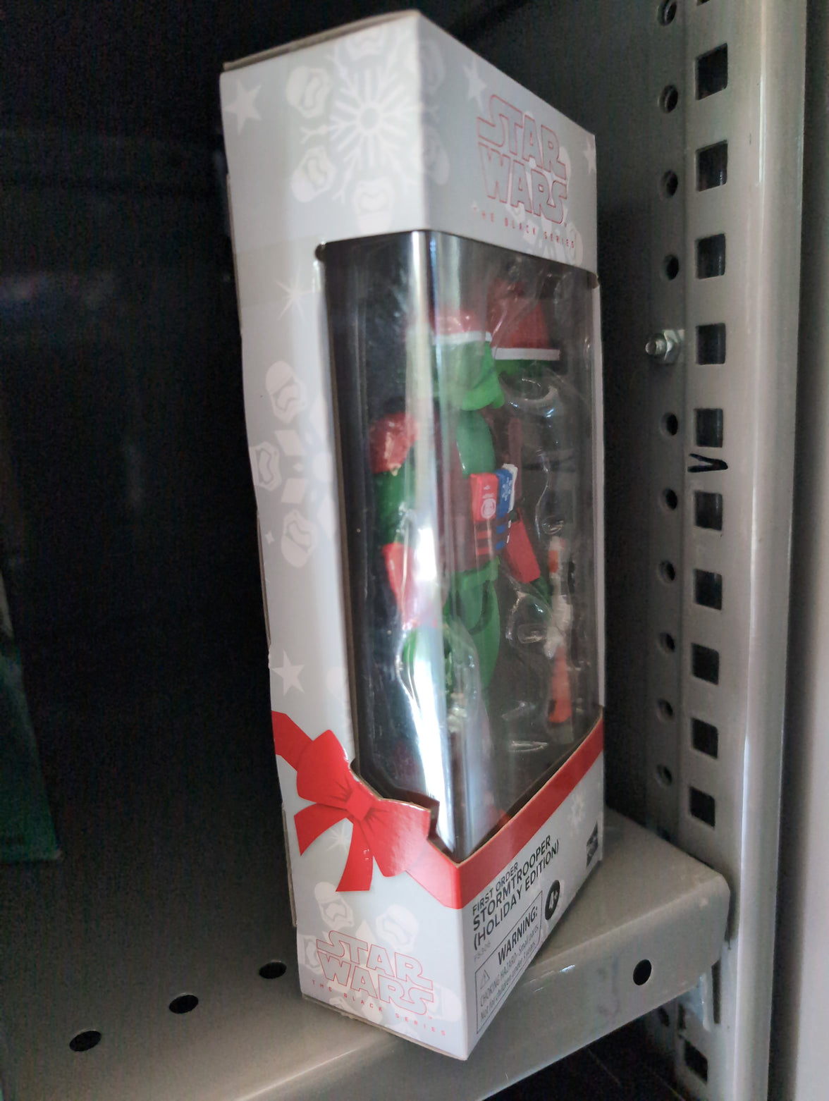 Hasbro Star Wars Holiday Scout Trooper action figure in festive packaging with Santa hat and holiday accessories