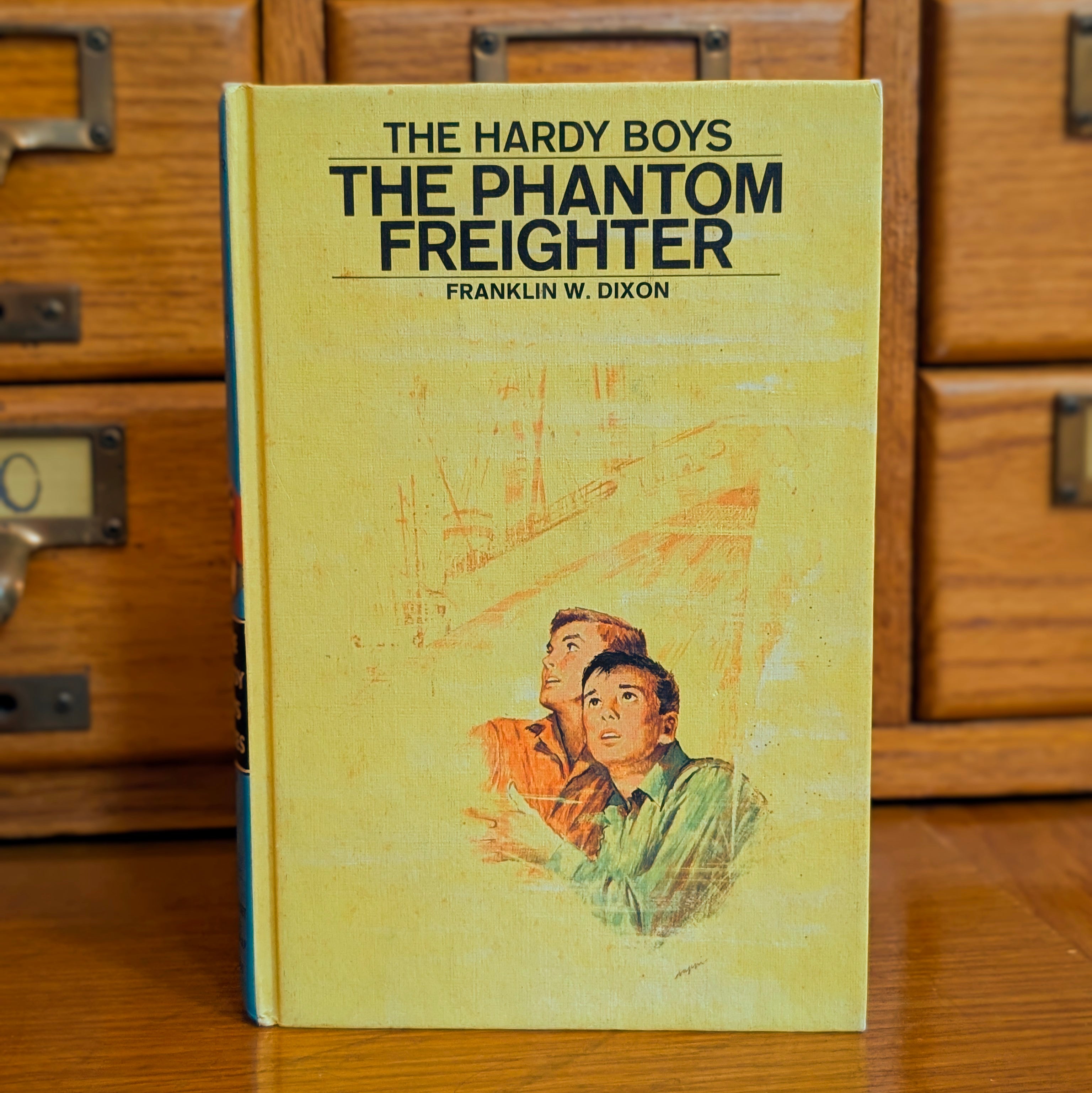 Vintage Hardy Boys book The Phantom Freighter hardcover by Grosset & Dunlap with illustration of two boys looking up