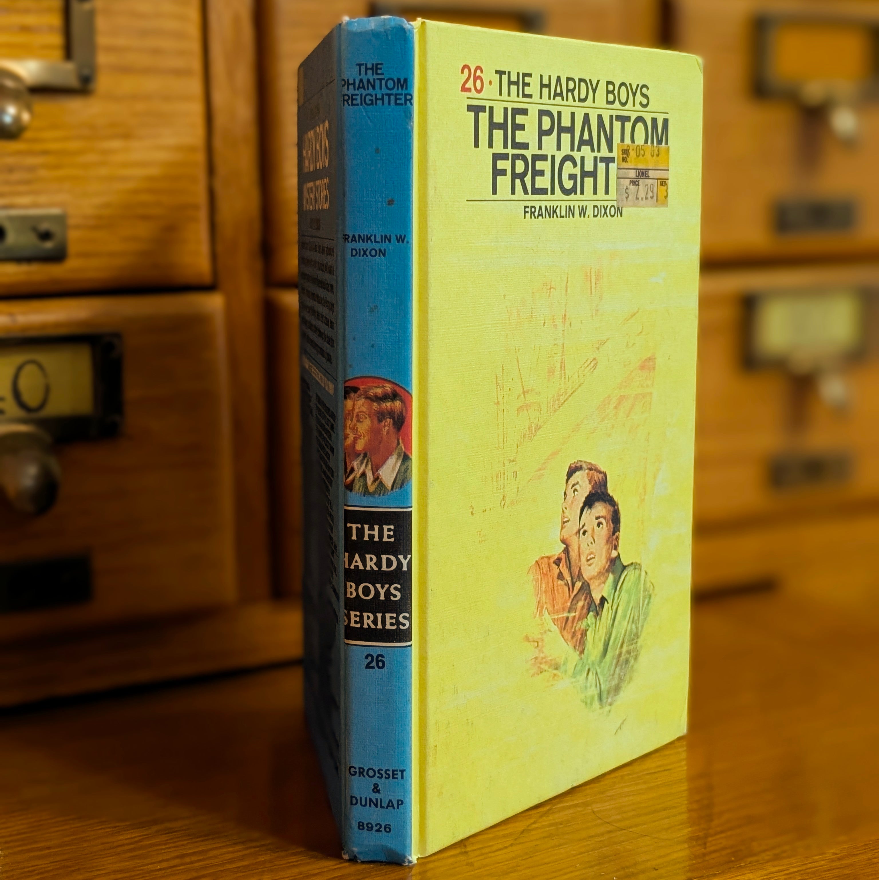 Vintage Hardy Boys book The Phantom Freighter #26 by Grosset & Dunlap with blue spine and yellow cover