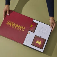 Hands opening Monopoly Signature Collection Premium Edition New Board Game by Hasbro with game components inside