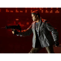 The Terminator T-800 Tech Noir Ultimate 7-Inch Scale Action Figure NECA posed with weapon in detailed jacket against dark background